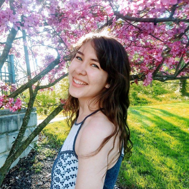 Tara Daniel in front of flowering trees