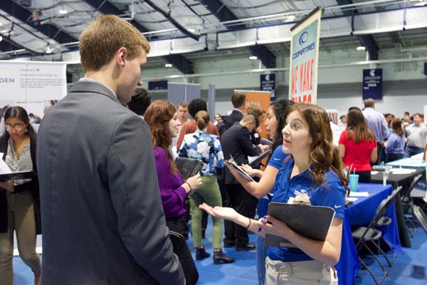 Student talking to a hiring manager at career fair