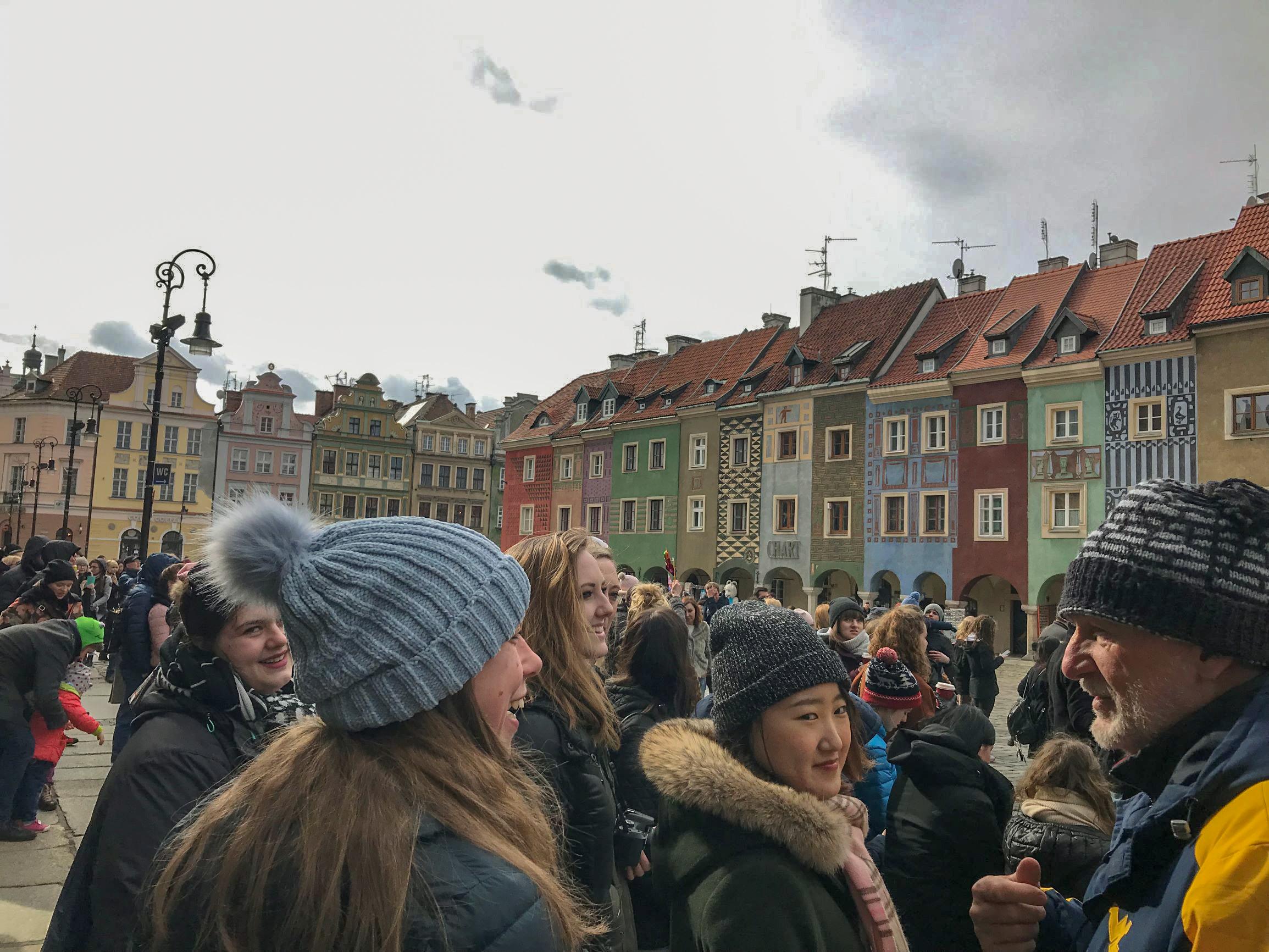 Study abroad group in front of old buildings in Poland