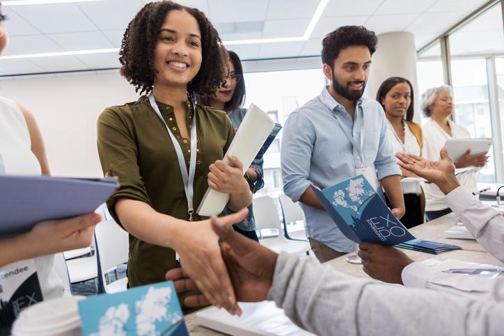 Students shaking hands with employers at a job fair