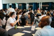 Students sitting at tables talking