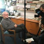 Image of Dr. Daniel J. Flannery being interviewed by News 5 Cleveland, sitting in chair in his office on left of image, with reporter and cameraman on right