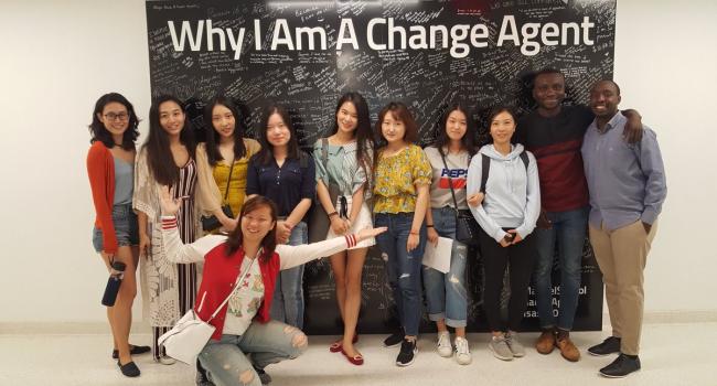 International class in front of the change agent wall