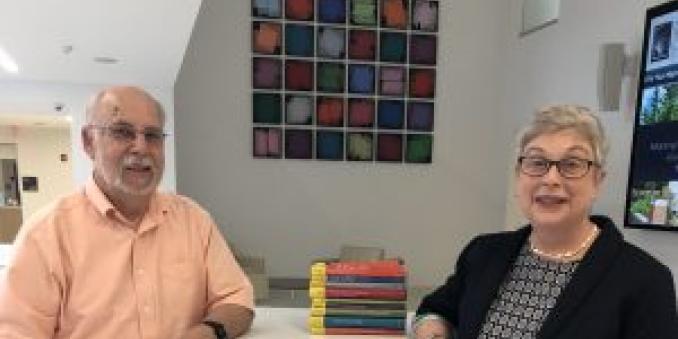 Image of David Biegel, PhD and Elizabeth M. Tracy, PhD sitting at a table with books