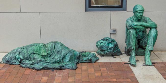 The Homeless sculpture on the steps of the Mandel School