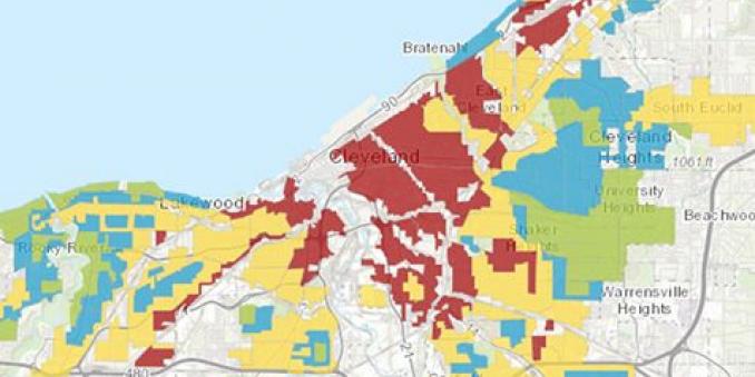 Image of map of redlining for cleveland, bratenal, cleveland heights, south euclid, beachwood, university heights warrensville heights shaker heights lakewood, rocky river and garfield heights, in green blue, yellow red, white and grey, with lake in blue on top