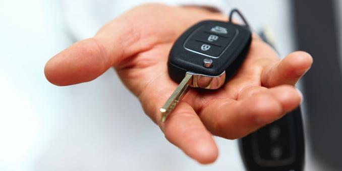 Hand outstretched holding car keys
