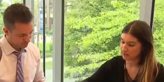 man and woman sitting at table talking