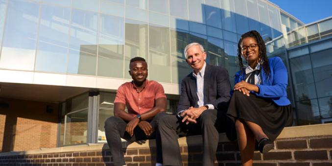 Kwame “Eddie” Botchway, David L. Hussey, PhD, and Cheyenne DeShields on the back steps of the Mandel School