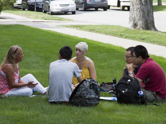Student sitting and talking in grass