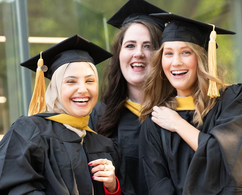 Three woman in graduation outfits