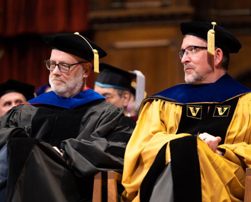 Dan Flannery and Rob Fischer clap during commencement 2023