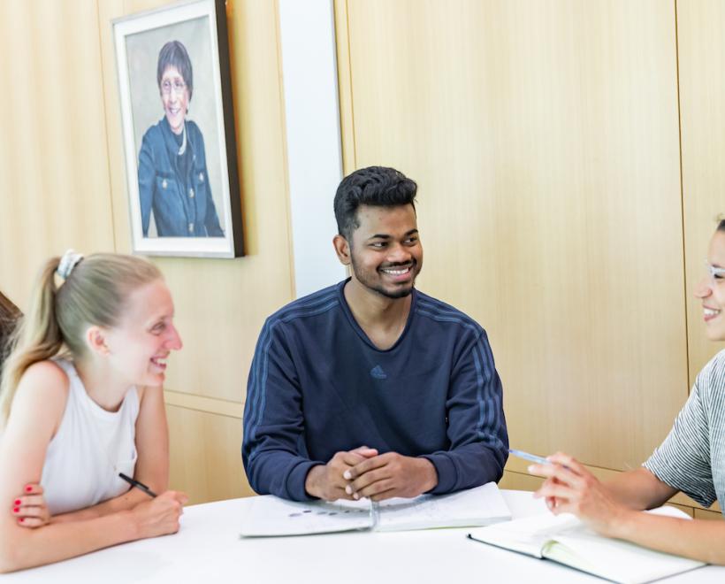 people sitting around a table talking