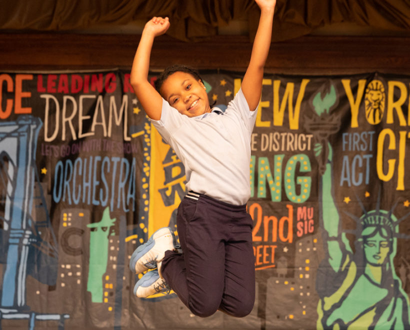 Child jumping on stage