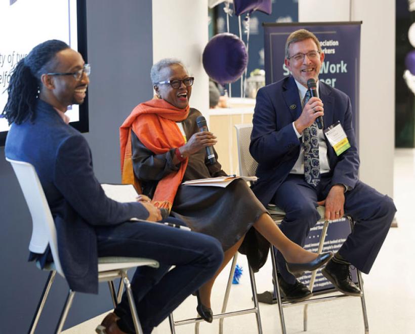 Sharon Milligan and Rob Fischer talk with a moderator during a Homecoming panel