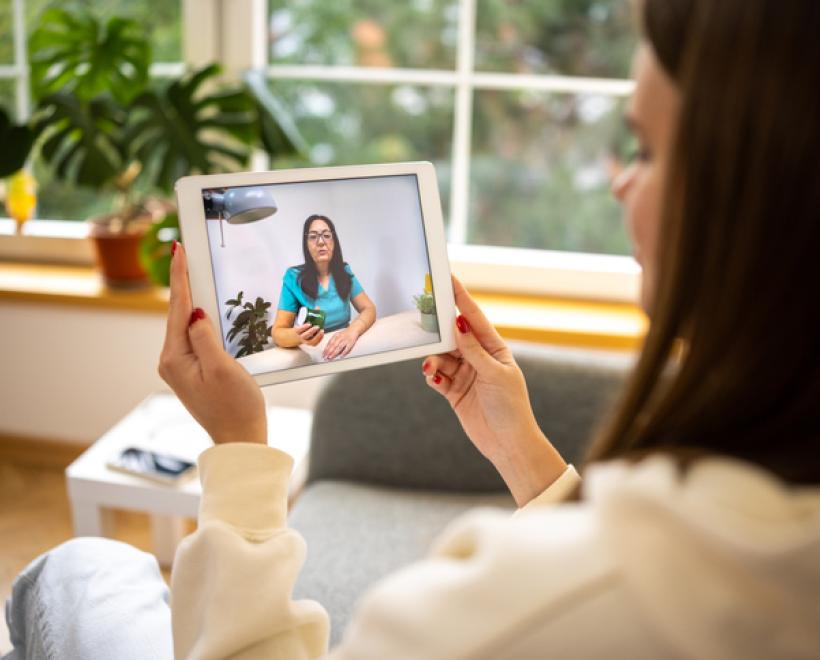 Person look at a woman talking on her tablet