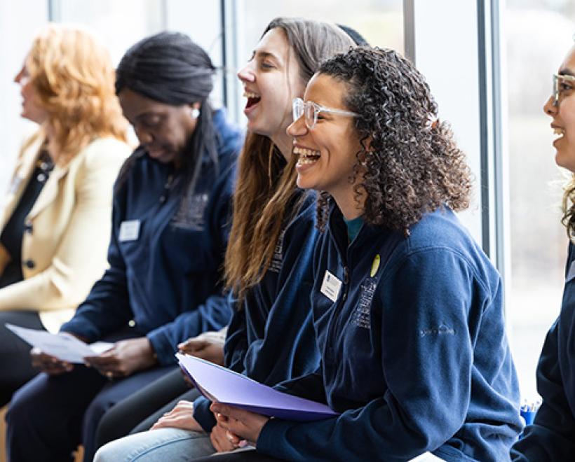Students looking forward and one laughing