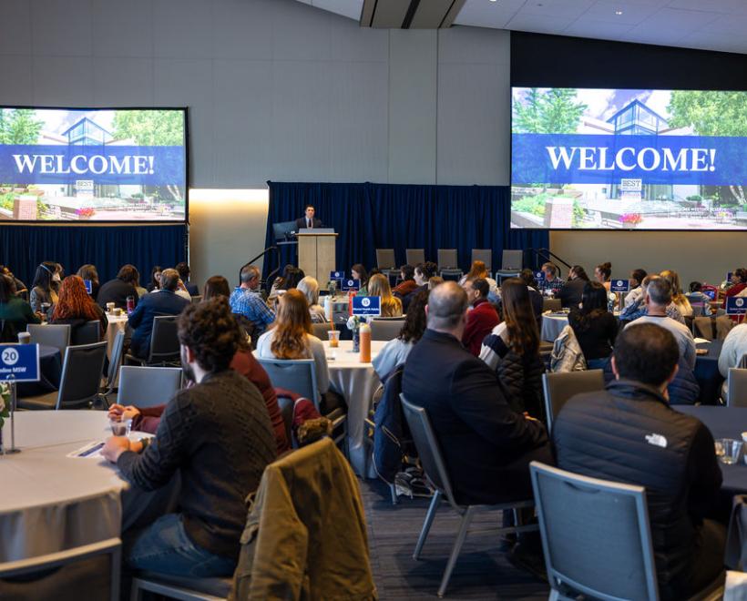 Room with prospective students watching a presentation