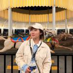 Feiran Yang in front of a carousel
