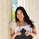 Elena Cangahuala holding her mortar board