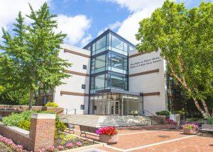 Image of outside photo of Jack, Joseph and Morton Mandel School of Applied Social Sciences with trees and front plaza with steps