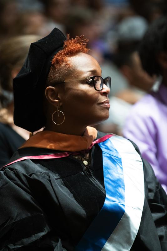 Profile of young woman in graduation robe and cap