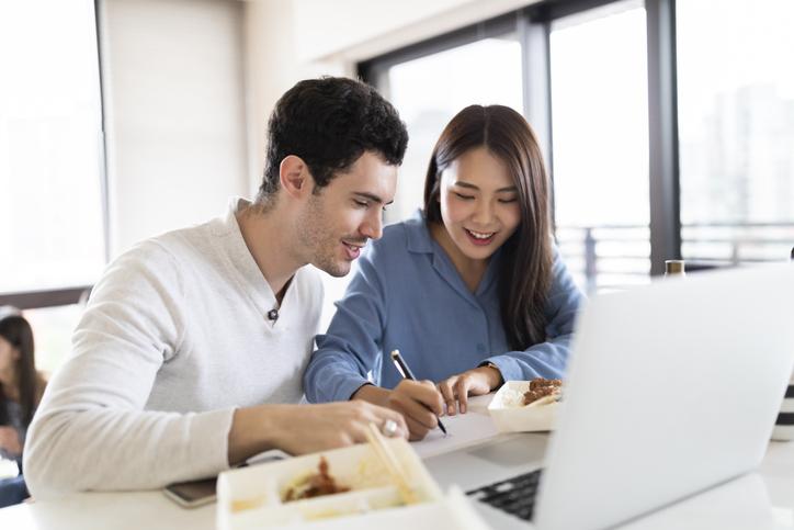 Two students working on a laptop