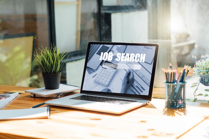 Open laptop on a desk with "Job Fair" on it