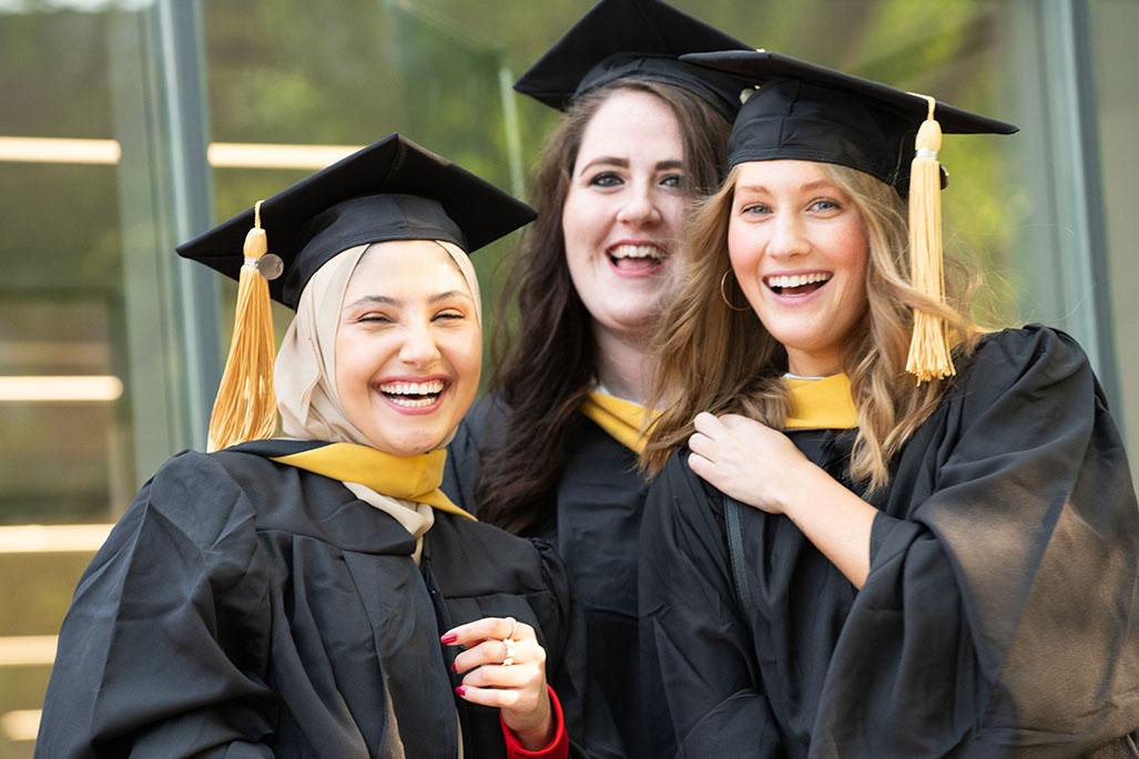 Three woman in graduation outfits