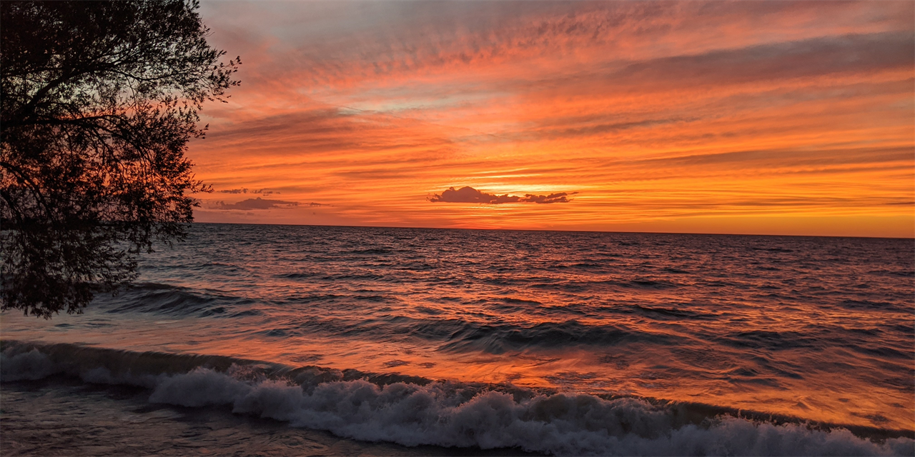 Ocean at sunset with an orange sky