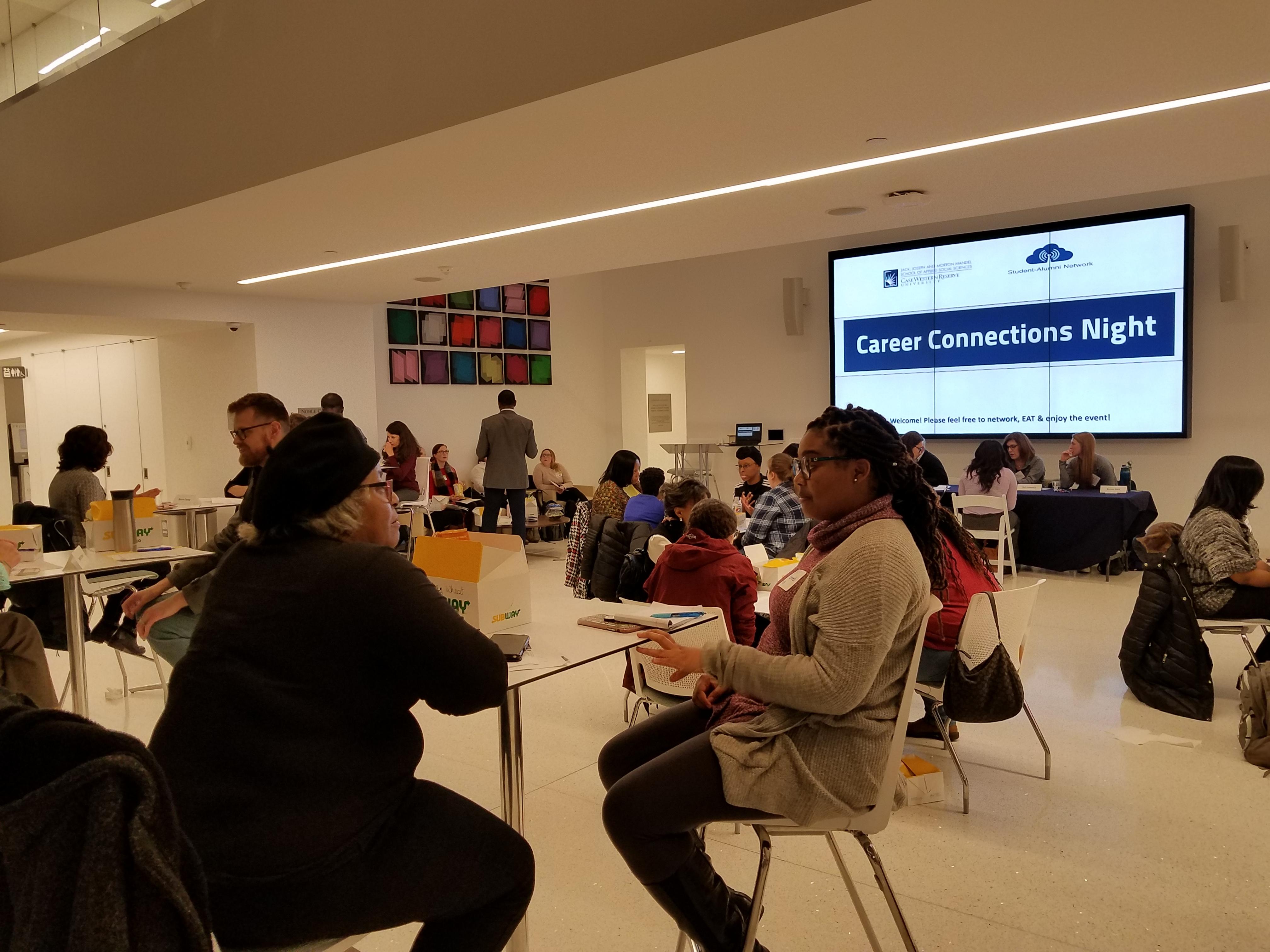 Students networking in Noble Commons