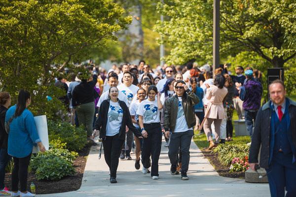 Students walking through 2023 clap out on Case Quad