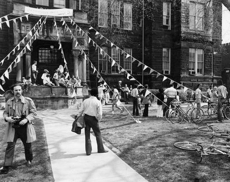 People standing outside Adelbert Hall with streamers coming down off it in a black and white picture