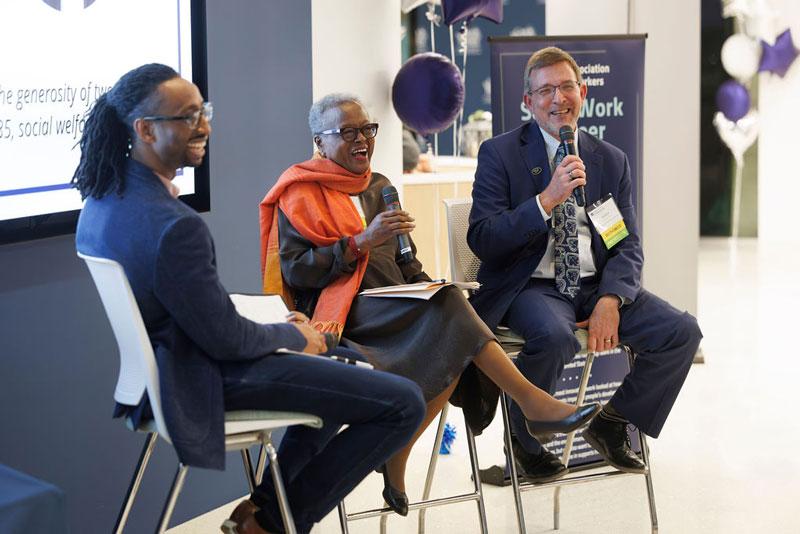 Sharon Milligan and Rob Fischer talk with a moderator during a Homecoming panel