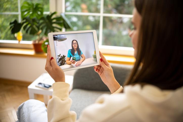 Person look at a woman talking on her tablet
