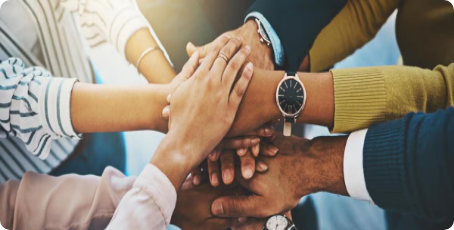 Many hands together on top of each other