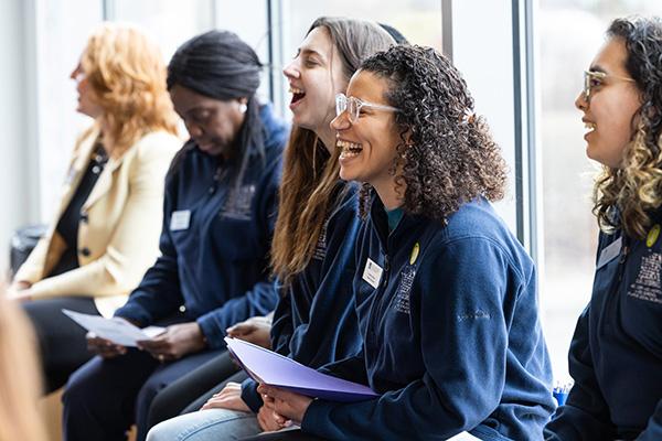 Students looking forward and one laughing