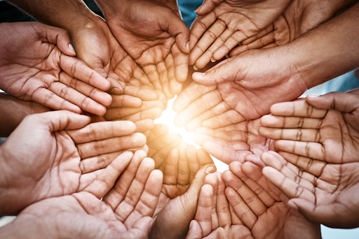 Hands forming a circle with light shining through