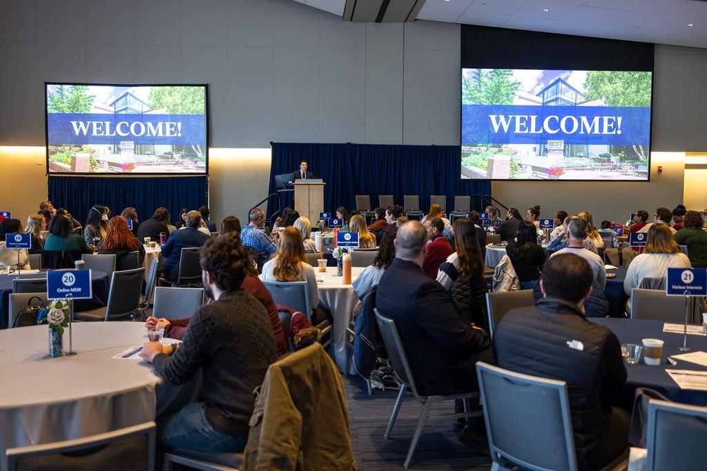 Room with prospective students watching a presentation