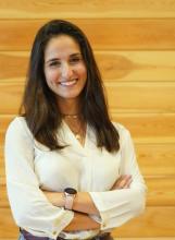 Emmanuelle Iskandar standing with arms crossed headshot