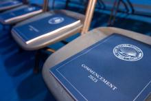 2025 Commencement books laid out on chairs