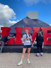Ellie Rumme stands in front of the "Live" sign at the Rock & Roll Hall of Fame