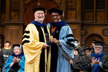 Cleve Gilmore and Dexter Voisin smile on stage at commencement