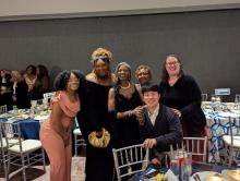 Mandel School students and faculty smile at a table at the 2025 Unity Banquet Awards