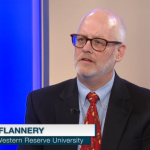 Image of Dr. Daniel J. Flannery as guest on Ideas, with caption in left corner with text Dan Flannery, case western reserve university, in blue and white, with a letter i in a circle
