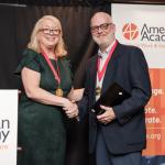 Dan Flannery shakes hands with the presenter of his AASWSW Fellow award