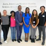 Lori Stokes and Dexter Voisin with students in the Mandel School building