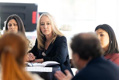Student sitting at a table looking at a speaker