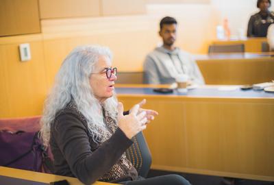 woman sitting at class talking to students