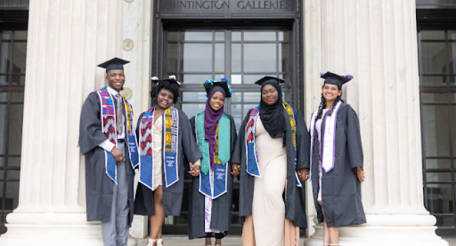 Five graduating students posing for camera